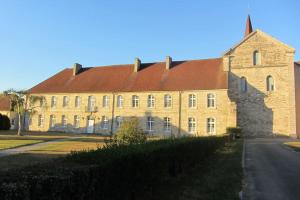 a large brick building with a red roof at Oncle xa 