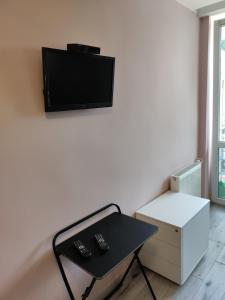 salon ze stołem i telewizorem na ścianie w obiekcie Prywatny pokój w Ośrodku Panorama Okuninka we Włodawie