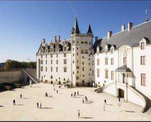 a group of people walking around a large building at CŒUR MENOU, Radis'son & PARKING in Nantes