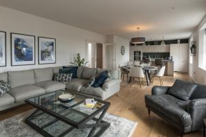 a living room with a couch and a table at Bath Penthouse with amazing views and lift access in Bath