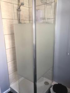 a shower with a glass door in a bathroom at Chequers in Doncaster