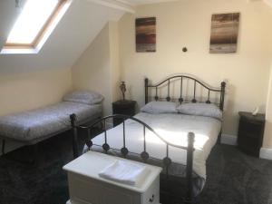 a bedroom with two beds and a window at Chequers in Doncaster