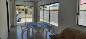 a dining room with blue tables and white chairs at Barra de Ibiraquera in Barra de Ibiraquera