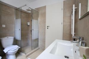 a bathroom with a shower and a toilet and a sink at GK Ermou Str in Athens +25 photos