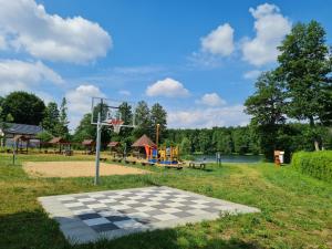 a park with a chess board and a playground at Mak i Rumianek in Parzeńsko