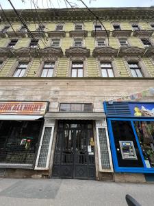un gran edificio con puertas y ventanas en una calle en Global Living - Deluxe Rakoczi Residence By Bella en Budapest