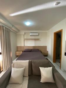 a bedroom with a large bed and a couch at Apartamento no Park Sul - Brasília in Brasilia +20 photos