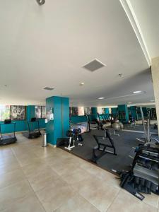 a gym with several treadmills and machines in it at Apartamento no Park Sul - Brasília in Brasilia