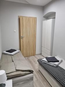a bedroom with two beds and a wooden door at Dom nad potokiem Opawa, na wyłączność, Karpacz, Opawa in Opawa +52 photos