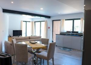 a kitchen and a living room with a table and chairs at Bela Vista Urtigosa in Arouca