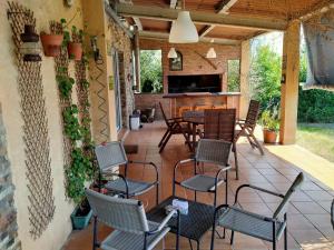 a patio with chairs and a table and a bar at Twin Pines Camino Norte in Arzúa