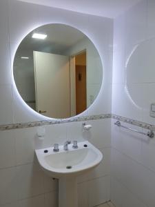 a bathroom with a white sink and a mirror at Monteagudo 847 in San Miguel de Tucumán