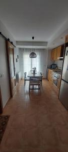 a kitchen with a table and a dining room at El HOGAR DE LAS MARIPOSAS - VUTE-22-057 in Valdelinares