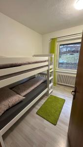 a bedroom with two bunk beds and a window at Ferienhaus Lara in Feld am See