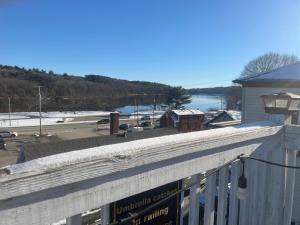 a balcony with a view of a body of water at Hallowell Rooming House in Hallowell