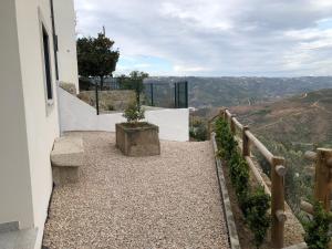 a stairway leading up to a white building with a view at Casa da Forja in Aldeia das Dez