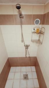 a shower with a drain in a bathroom at Chata Koza in Bublava