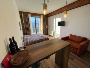 a living room with a table and a couch at New Gudauri, Alpic, Gudauri in Gudauri