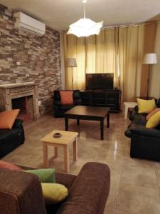 a living room with couches and a fireplace at Rosa Farm, Jerash Most Beautiful Villa in Jerash