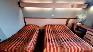 Postel nebo postele na pokoji v ubytování Hôtel Siatel Besançon Chateaufarine