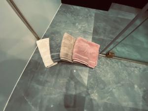 a pair of towels sitting on top of a tile floor at TALIA Apartament Tatarska 4 in Przemyśl
