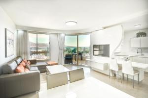 Golf Residence By Sun and View في إيلات: غرفة معيشة مع أريكة وطاولة