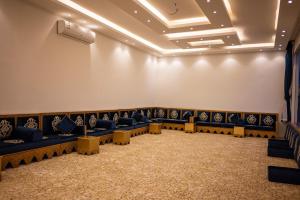 a waiting room with blue couches and tables at منتجع وإسطبل الهدوء in Riyadh