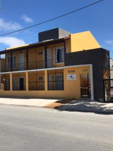 a yellow and black building on the side of a street at Lázaro & Diana in San Clemente del Tuyú