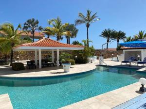 a swimming pool in a resort with palm trees at Villa Olympia, St James Club - Luxury Open plan Villa, with Private Pool & 2 Kitchens in Bats Cave