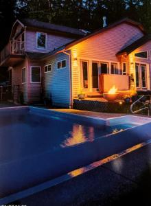 a house with a swimming pool in front of a house at luxury ocean dock pool villa in Ladysmith