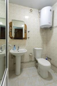 a bathroom with a toilet and a sink at Mariam's Apartment in Kutaisi