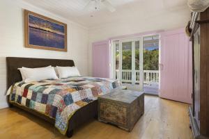 a bedroom with a bed and a window at Miranda House home in Governorʼs Harbour