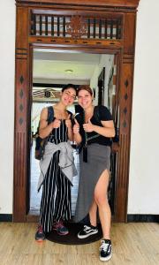 two women are posing in front of a mirror at Heritage villa polonnaruwa in Polonnaruwa