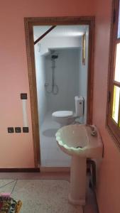 a bathroom with a sink and a toilet at Chez L'habitant Brahim kanih in Anzel
