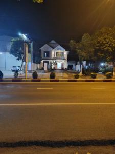 a house sitting on the side of a street at night at Khôi Đại Hotel - gần sân bay Buôn Ma Thuột, near Buon Ma Thuot Airport in Buon Ma Thuot