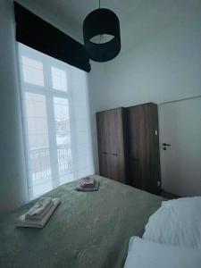 a bedroom with a large bed and a large window at TALIA Apartament Tatarska 4 in Przemyśl
