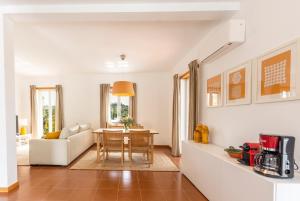 a living room with a table and a couch at Quinta da Asneira in Montemor-o-Novo