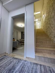 a hallway with a staircase in a house at Hilton Burgas Holiday Home in Burgas City