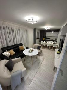 a living room with a couch and a table at Hilton Burgas Holiday Home in Burgas City