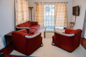 a living room with two chairs and a couch at JR Apartments in Georgetown