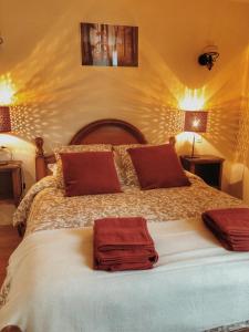 um quarto com uma cama grande com duas toalhas em Gîte Les Roches : maison de caractère pour 15 personnes em Saint-Romain