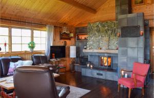 a living room with a fireplace and a couch at 3 Bedroom Amazing Home In Nord-torpa in Nord Torpa