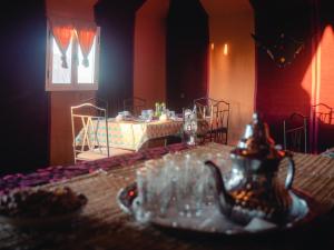 a room with a table with a tea pot on it at Desert Camp Erg Chebbi in Merzouga