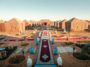 a group of tents in the middle of a desert at Desert Camp Erg Chebbi in Merzouga