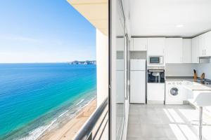 a kitchen with a view of the ocean at Torre Levante 24-B Levante Beach in Benidorm