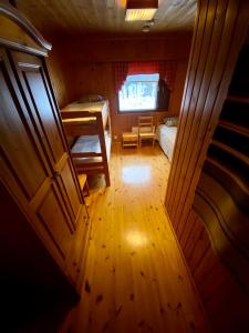 a small room with two beds and a window at Villa Rapakivi in Heinola