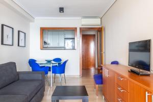 カルプにあるParadero Rental S74 - Vistas al Marのリビングルーム(ソファ、テーブル、青い椅子付)