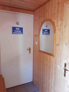 a bathroom with a white door and a mirror at Ferienwohnung und Monteurwohnung Schulz in Königs Wusterhausen