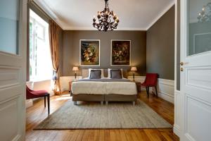 Saint-Honoré-les-BainsにあるDomaine des Myosotis, holiday homeのベッドルーム1室(ベッド1台付)が備わります。壁には絵画2点が飾られています。