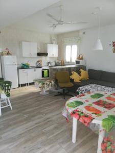 a kitchen and living room with a couch and a table at Almerimar Paraiso al Mar in Balerma